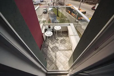 a balcony with tables and chairs on a building at Paradise Guest Apartment in Sofia