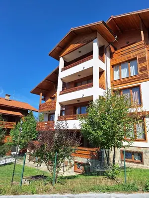 a building with a fence in front of it at Cozy studio with balcony and incl SPA in 4-star hotel Saint Ivan Rilski , Bansko in Bansko