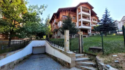 a house with a staircase in front of a building at Cozy studio with balcony and incl SPA in 4-star hotel Saint Ivan Rilski , Bansko in Bansko