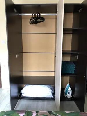 a shelf in a closet with a football on it at Superb apartment Free Underground Parking in Pazardzhik