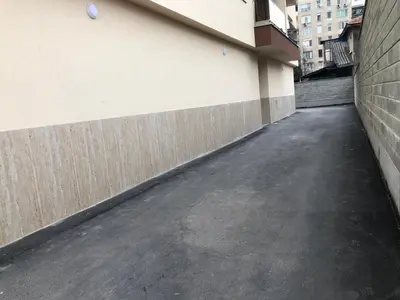 an empty alley next to a building with a wall at Superb apartment Free Underground Parking in Pazardzhik