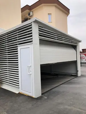 a garage with a door and a building at Superb apartment Free Underground Parking in Pazardzhik