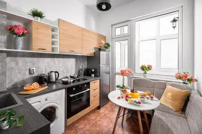 a small kitchen with a table and a couch at Free Parking And Parliament Is 1 Step Away in Sofia