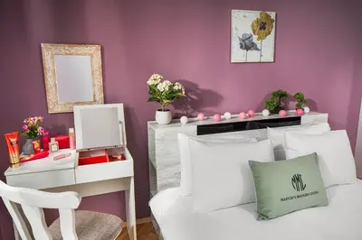 a bedroom with a white bed and a purple wall at Free Parking And Parliament Is 1 Step Away in Sofia