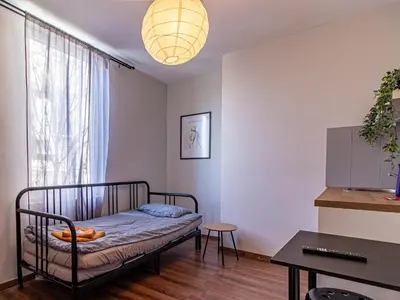 a bedroom with a bed in a room with a window at Vitosha Viewpoint - Chic City Studio in Sofia