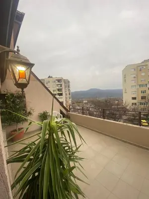 a balcony with a street light and a plant at Мезонет “Djanina” in Sandanski