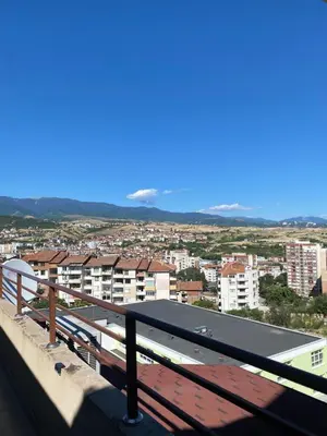 a view of a city from the balcony of a building at Мезонет “Djanina” in Sandanski