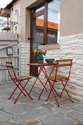 a table and two chairs sitting next to a building at Studio Panagyurishte in Panagyurishte