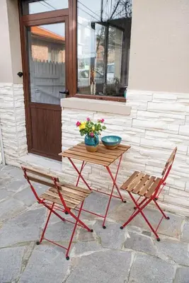 a table and two chairs sitting next to a window at Studio Panagyurishte in Panagyurishte