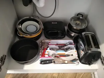 a shelf with various kitchen utensils on it at Studio Panagyurishte in Panagyurishte