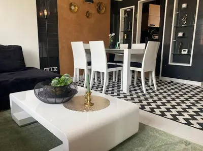a living room with a white table and chairs at Lovely 1-bedroom apartament with free parking in Sofia