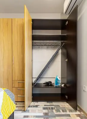 a bedroom with a closet with black shelves at Florance flat next to Old Town & City Center NEW in Plovdiv