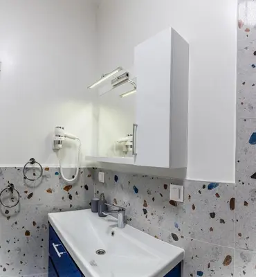 a bathroom with a white sink and a mirror at Sofia Apartment with Free Parking in Sofia