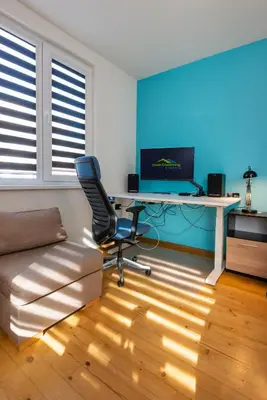 a living room with a desk and a chair at DevIn Coworking & Coliving in Devin