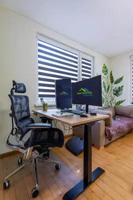 a room with a desk with two computer monitors on it at DevIn Coworking & Coliving in Devin