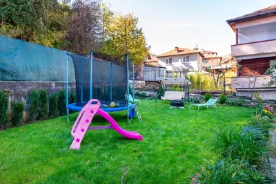 a playground with a slide in a yard at DevIn Coworking & Coliving in Devin