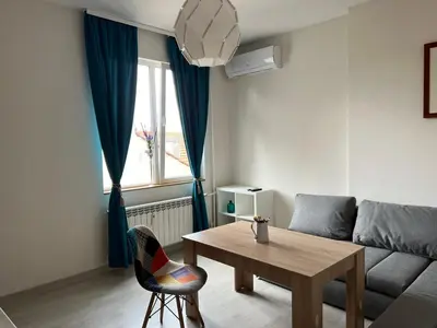 a living room with a table and a couch at Vitosha 60 in Sofia