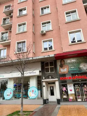 a tall red brick building on a city street at Vitosha 60 in Sofia