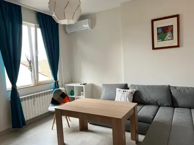 a living room with a couch and a table at Vitosha 60 in Sofia