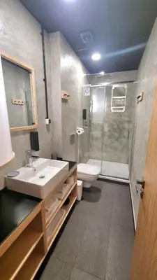 a bathroom with a sink and a shower and a toilet at Art Hotel 158 in Sofia