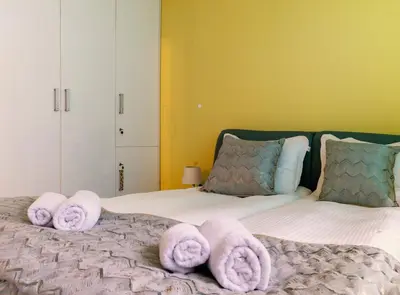 a bedroom with a bed with towels on it at Sofiel cozy apartment - Top Center Sofia in Sofia