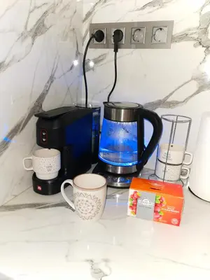 a coffee maker and cups on a counter at Sofiel cozy apartment - Top Center Sofia in Sofia