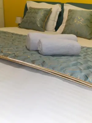 a mirror on a bed with towels on it at Sofiel cozy apartment - Top Center Sofia in Sofia