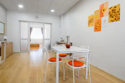 a dining room with a white table and chairs at 2BD Citrus Apartment, Aristocratic Sofia Living by Flat Mаnager in Sofia