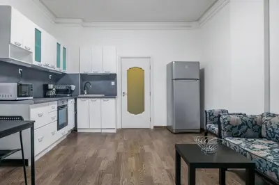 a kitchen and living room with a couch and a refrigerator at 2BD Citrus Apartment, Aristocratic Sofia Living by Flat Mаnager in Sofia