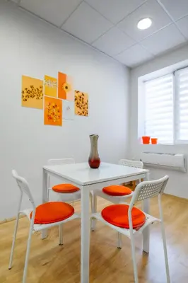 a white table with four chairs and a vase on it at 2BD Citrus Apartment, Aristocratic Sofia Living by Flat Mаnager in Sofia
