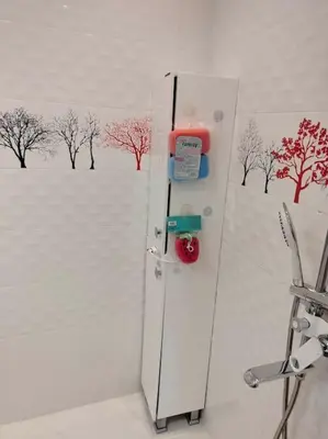 a white refrigerator with a painting of a field at Alinik Apartment in Sofia