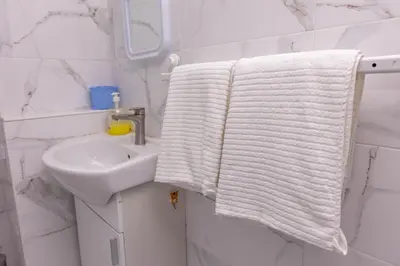 a bathroom with a white towel hanging next to a sink at Apartement Hérmitage in Sandanski