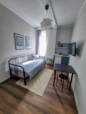 a bedroom with a bed and a table at Cozy Studio in Center of Sofia in Sofia
