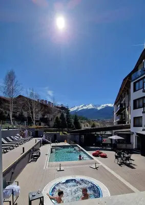 a large swimming pool with people in it at St Ivan Rilski Free SPA Luxury Apartment Bansko in Bansko