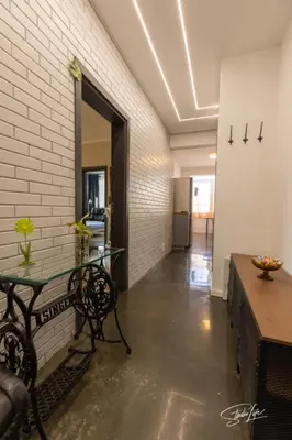 a hallway with a table and a bench in a room at La Corte dei Bohem in Sofia