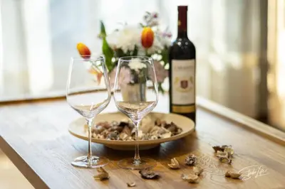 a table with two wine glasses and a bottle of wine at La Corte dei Bohem in Sofia