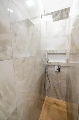 a shower with a glass door in a bathroom at Vitoshka's Finest in Sofia