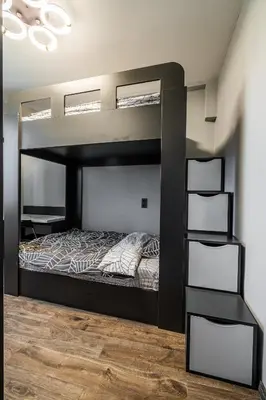 a black bunk bed in a room with a wooden floor at Vitoshka's Finest in Sofia