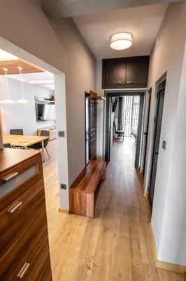 a kitchen and dining room with a wooden bench in a house at Vitoshka's Finest in Sofia