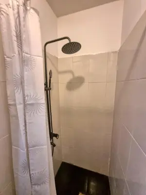 a shower with a shower curtain in a bathroom at Welcoming Studio in Sofia Center in Sofia