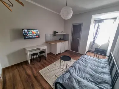 a bedroom with a bed and a desk in a room at Welcoming Studio in Sofia Center in Sofia