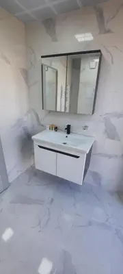 a white bathroom with a sink and a mirror at Zora in Blagoevgrad