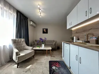 a kitchen and living room with a couch and a table at Old Town Apartment 3 with Free Private Parking in Plovdiv
