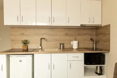 a kitchen with white cabinets and a sink at Old Town Apartment 3 with Free Private Parking in Plovdiv