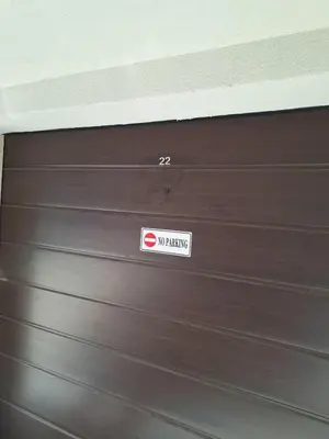 a brown garage door with a sign on it at Old Town Apartment 3 with Free Private Parking in Plovdiv