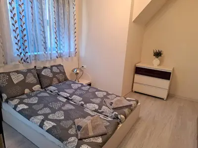 a small bedroom with a bed and a dresser at Old Town Apartment 3 with Free Private Parking in Plovdiv