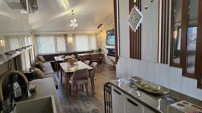 a restaurant with tables and chairs in a room at ЕЛЕГАНС къща за гости in Dospat