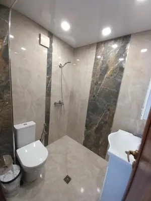 a bathroom with a toilet and a shower and a sink at ЕЛЕГАНС къща за гости in Dospat