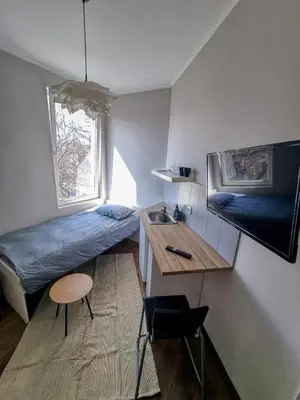 a small room with a bed and a sink at Inviting Studio in Sofia Center in Sofia