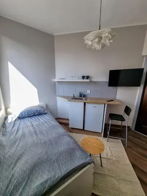 a bedroom with a bed and a table and a desk at Inviting Studio in Sofia Center in Sofia